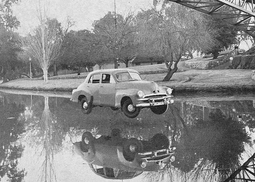 FJ Holden hanging from bridge